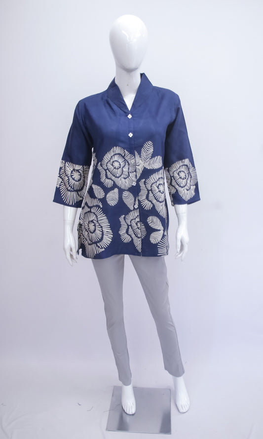 Mannequin wearing a blue floral-patterned shirt with white flowers on a white background