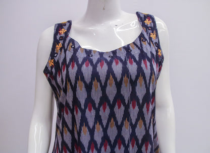 Mannequin wearing a sleeveless top with a geometric pattern on a white background