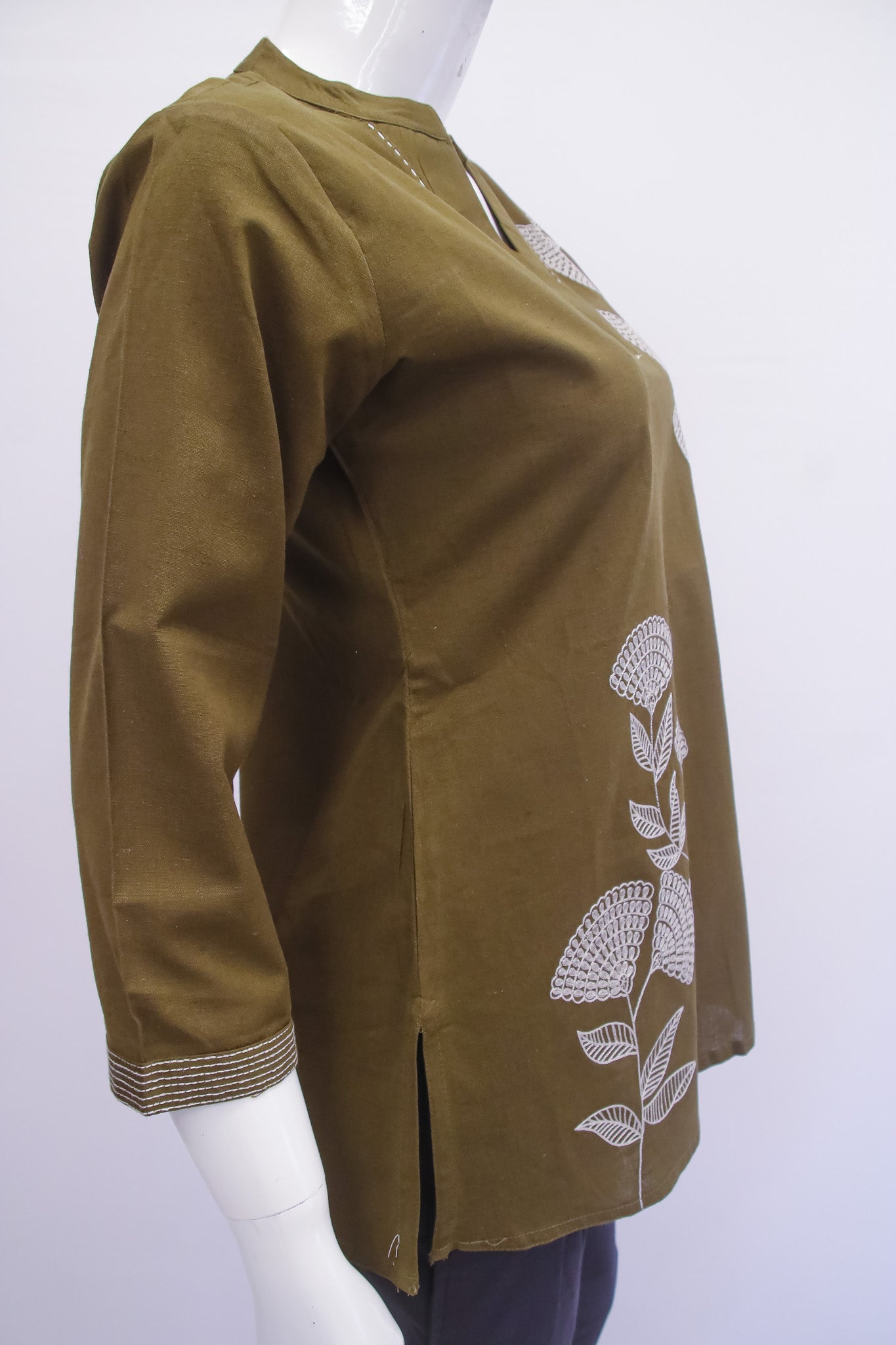 Brown jacket with floral embroidery on a mannequin against a white background