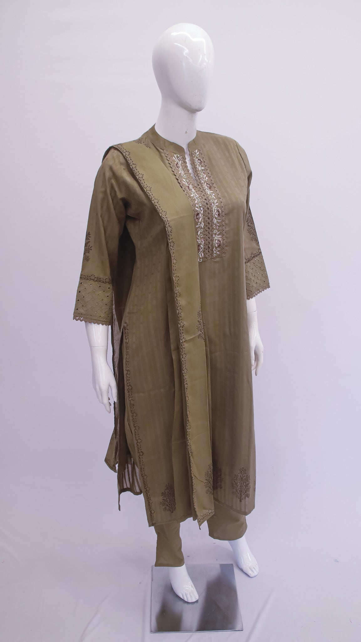 Olive green dress with intricate detailing on a mannequin against a white background