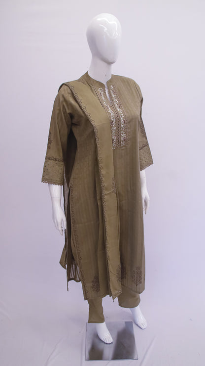 Olive green dress with intricate detailing on a mannequin against a white background