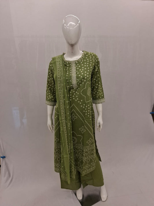 Green patterned dress on a mannequin against a gray background