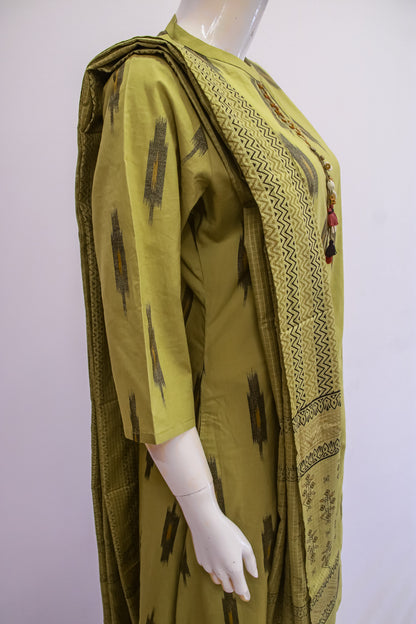 Green patterned garment on a mannequin against a white background