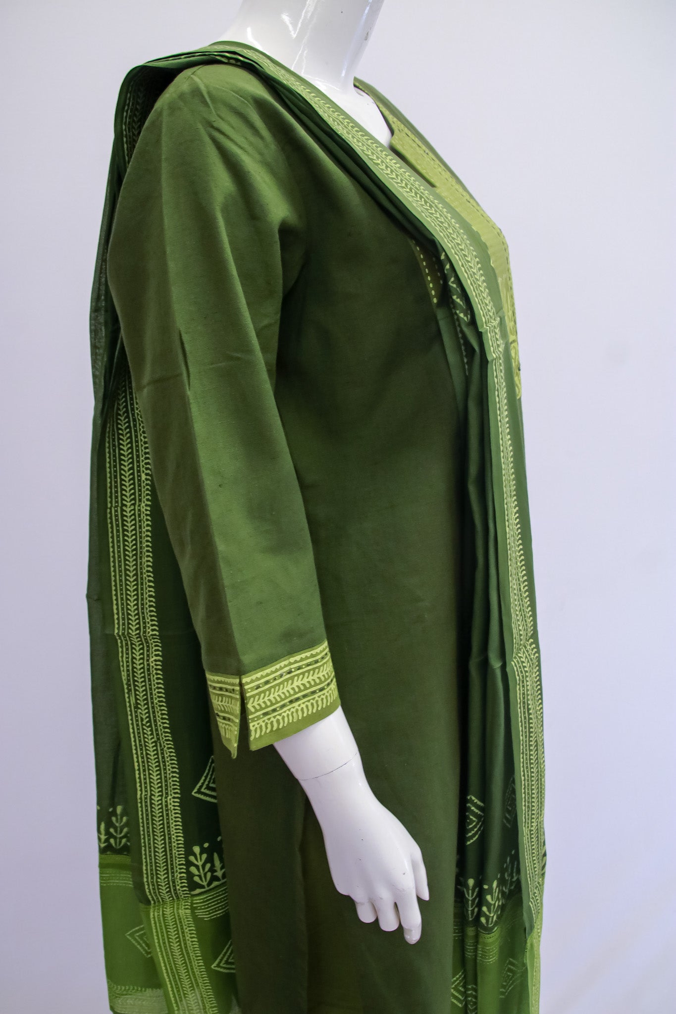 Green dress with intricate patterns on a white background