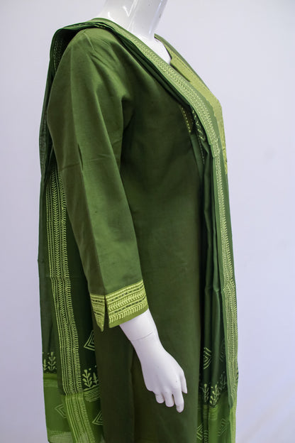 Green dress with intricate patterns on a white background