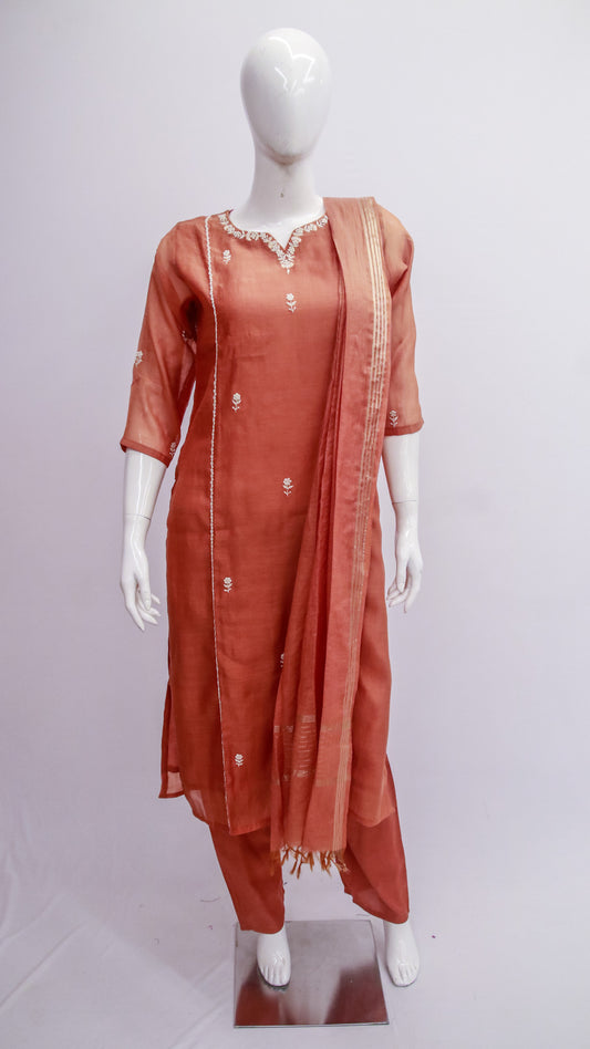 Mannequin wearing a rust-colored traditional outfit with a dupatta on a white background