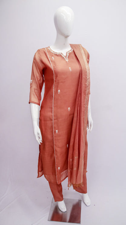 Mannequin wearing a rust-colored traditional outfit with a dupatta on a white background