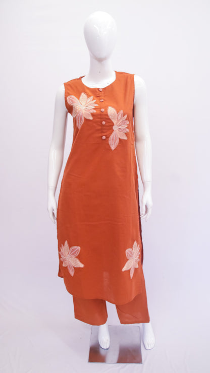Orange dress with floral patterns on a mannequin against a white background