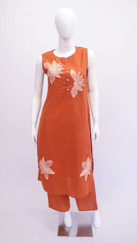 Orange dress with floral patterns on a mannequin against a white background