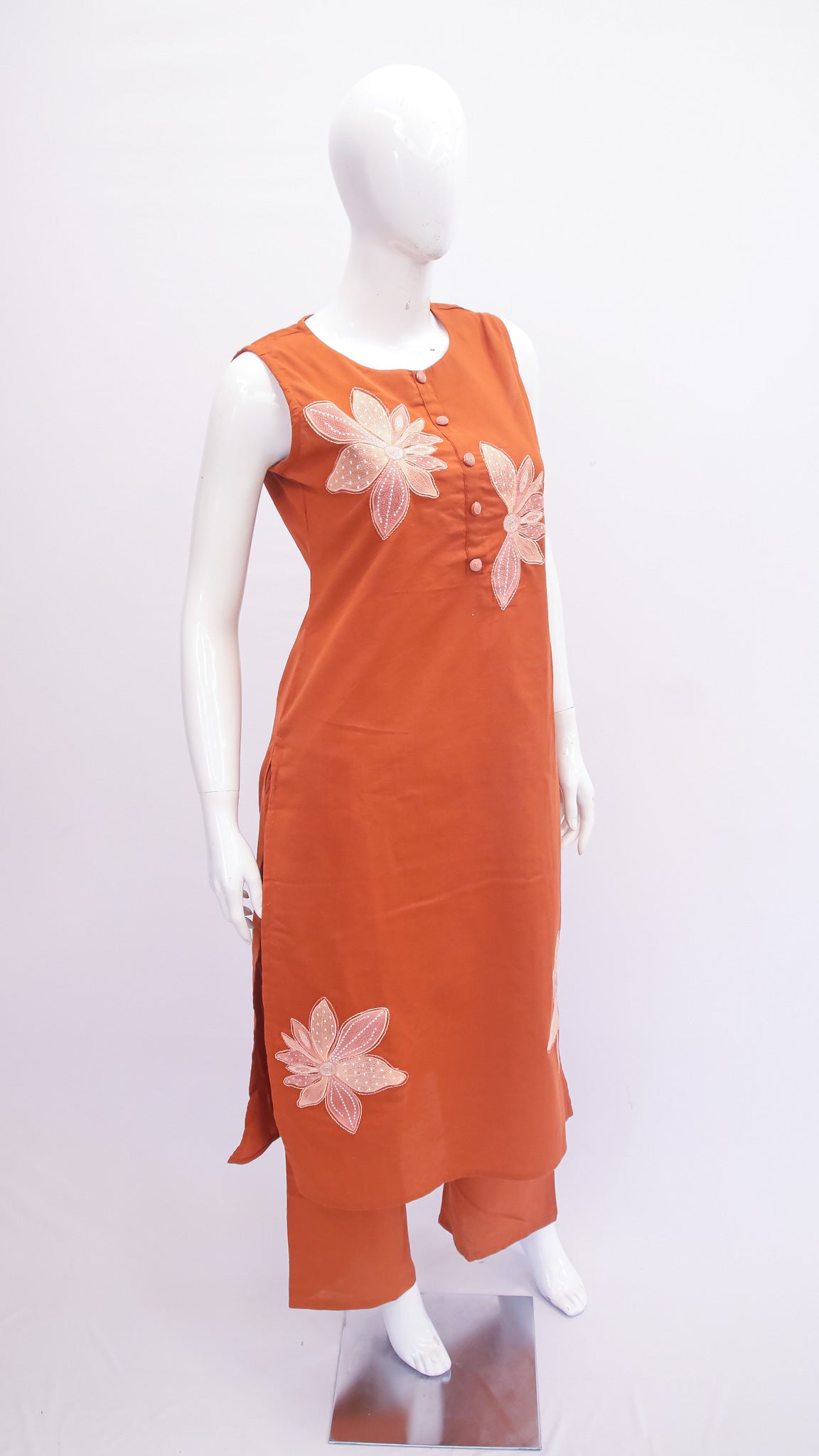 Orange dress with floral patterns on a mannequin against a white background