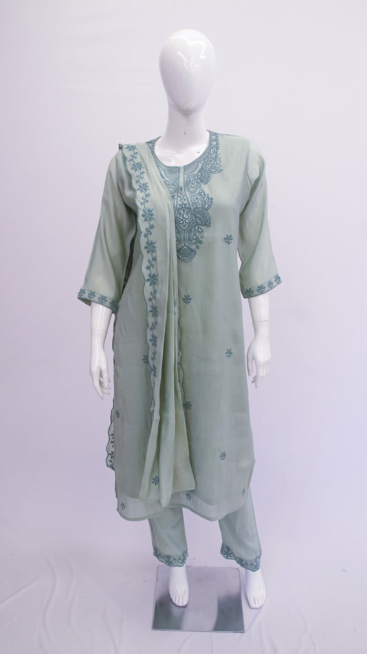 Green embroidered outfit on a mannequin against a white background