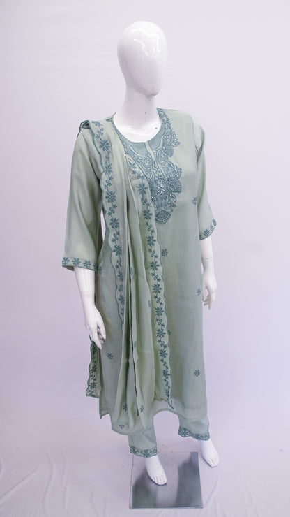 Green embroidered outfit on a mannequin against a white background