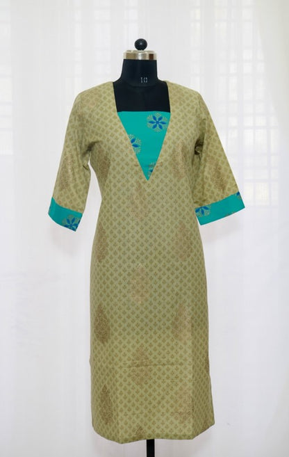 A Bluish Green cotton kurta with patchwork on the yoke and 3/4th sleeves, displayed on a mannequin.