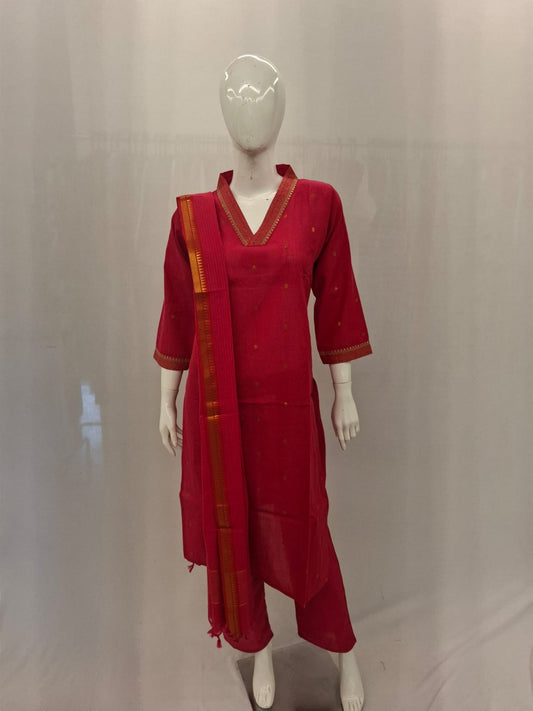 Red traditional outfit with a sari on a mannequin against a plain background