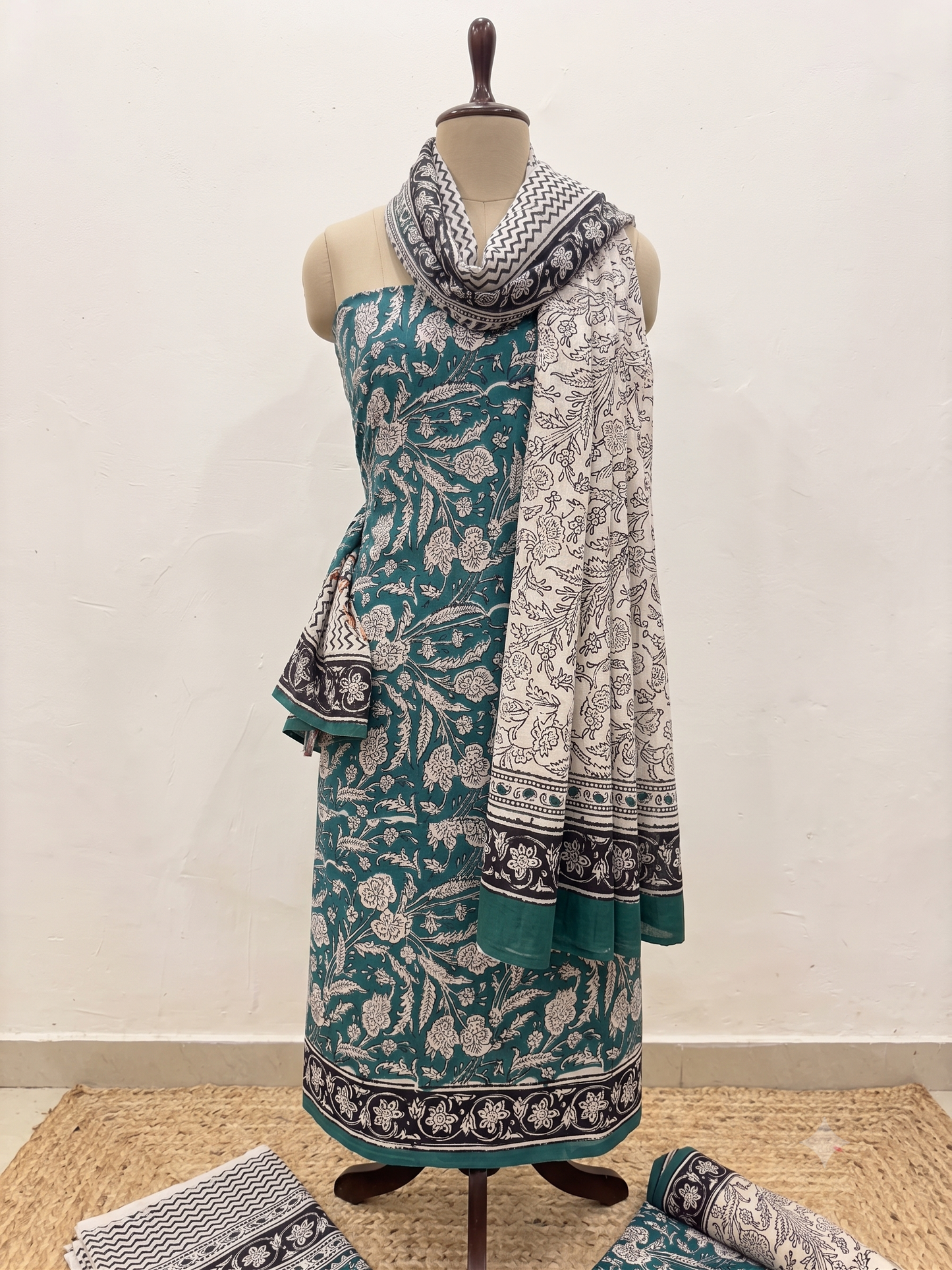 Premium Cotton Teal Green Floral Printed Unstitched Dress Material with Matching Cotton Bottom and Printed Dupatta by Udojas Sutra.