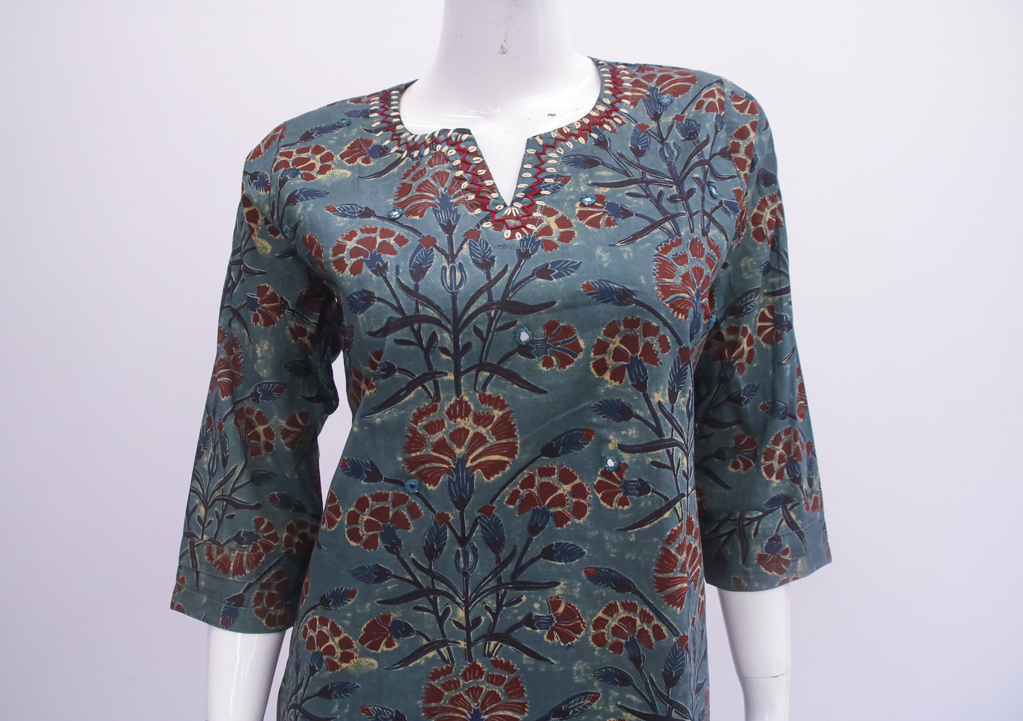 Floral patterned top on a mannequin against a white background