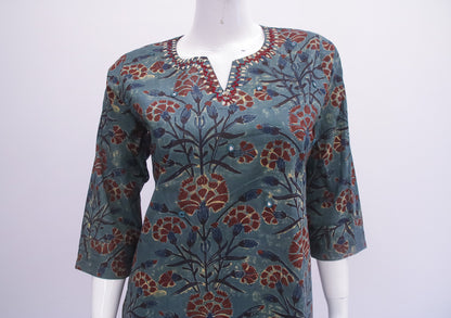 Floral patterned top on a mannequin against a white background
