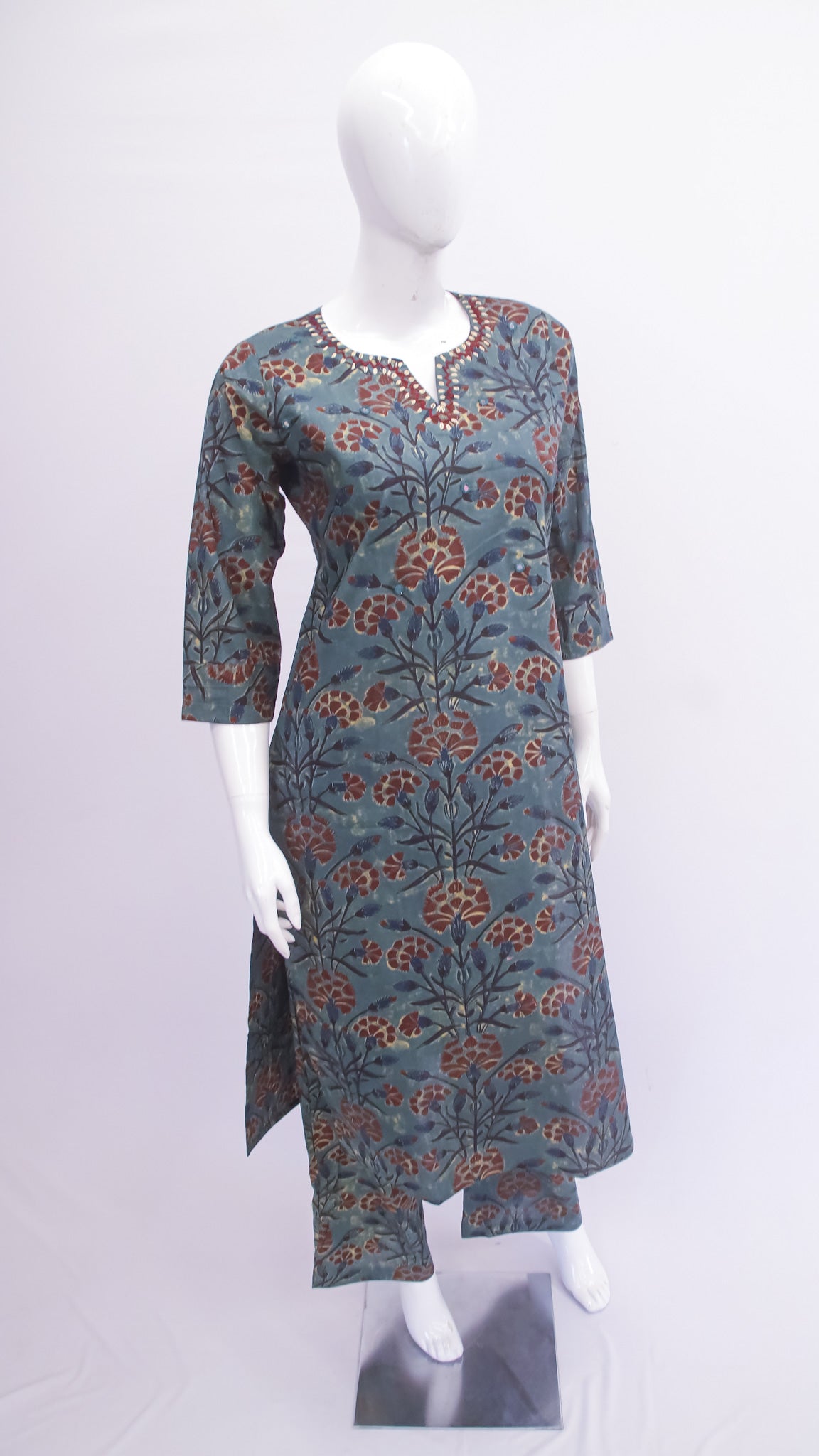 Floral patterned dress on a mannequin against a white background