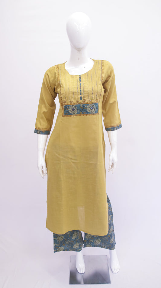 Mannequin wearing a mustard yellow kurta with blue embroidery on a white background