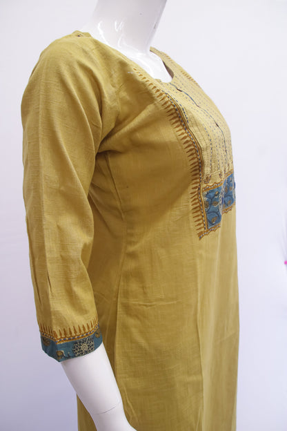 Mustard yellow kurta with blue embroidery on a white background
