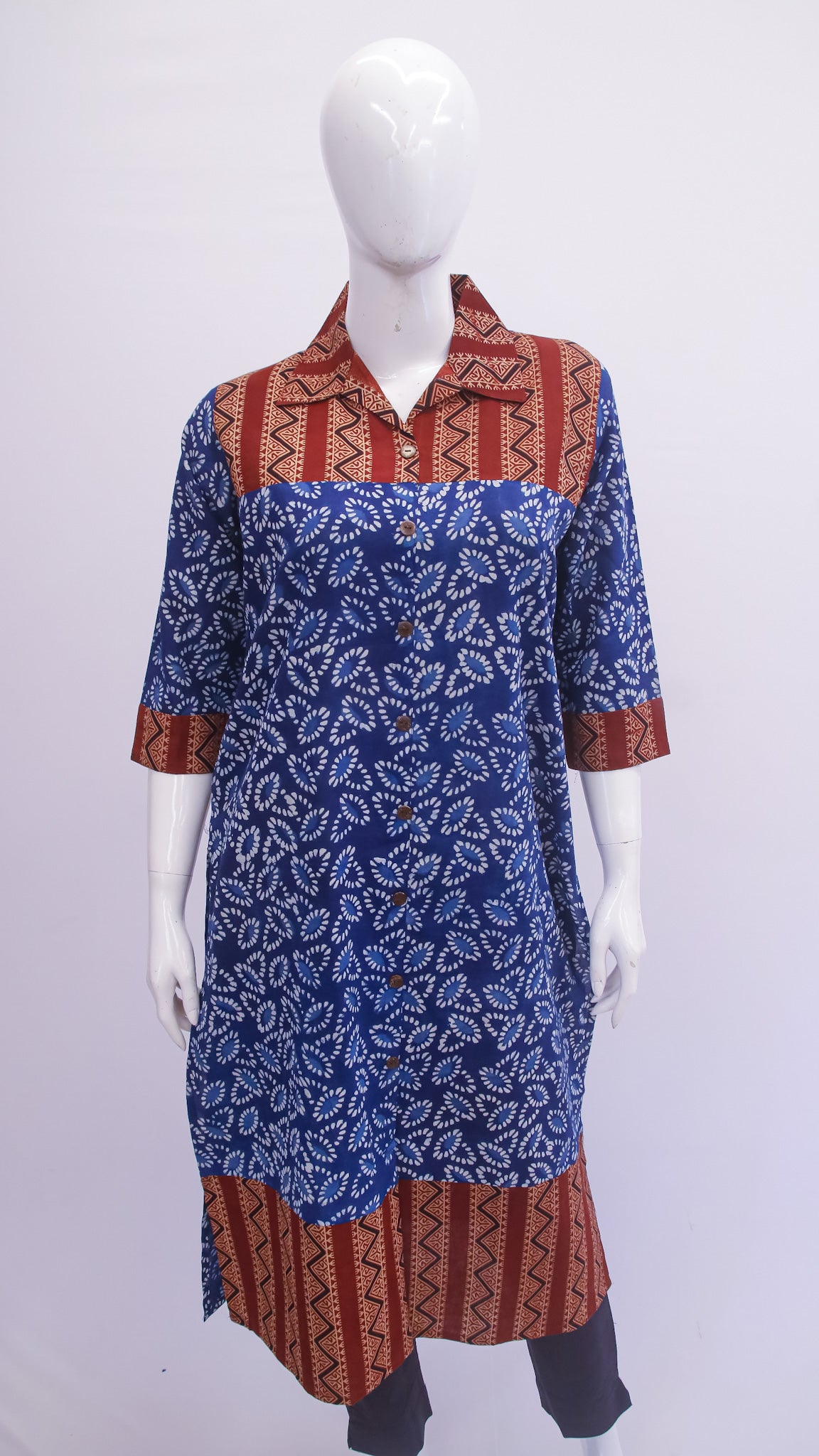 Mannequin wearing a blue and red patterned dress on a white background