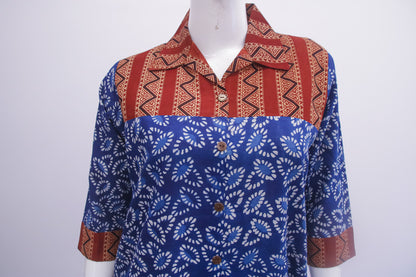 Mannequin wearing a blue and red patterned shirt on a white background