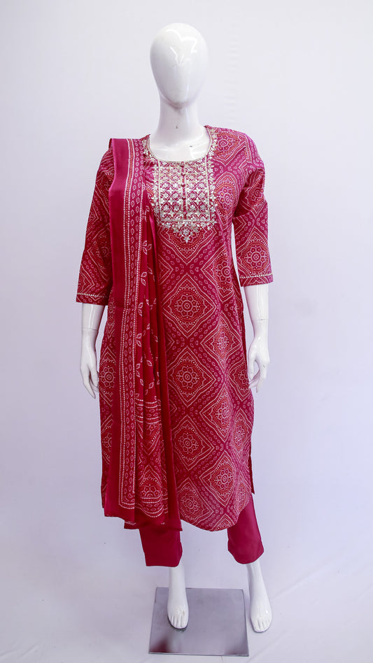 Red patterned kurta with matching pants on a mannequin against a white background