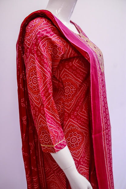 Red patterned fabric draped over a mannequin on a white background