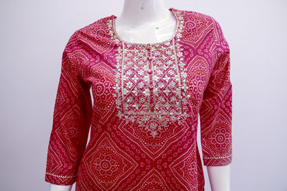 Red patterned top on a mannequin against a white background
