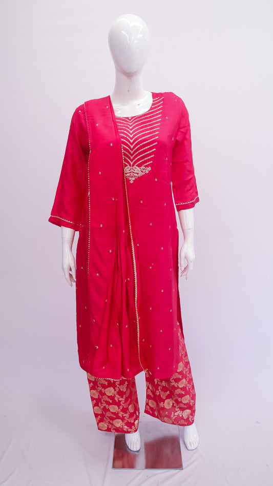 Red traditional outfit with matching dupatta on a mannequin against a white background