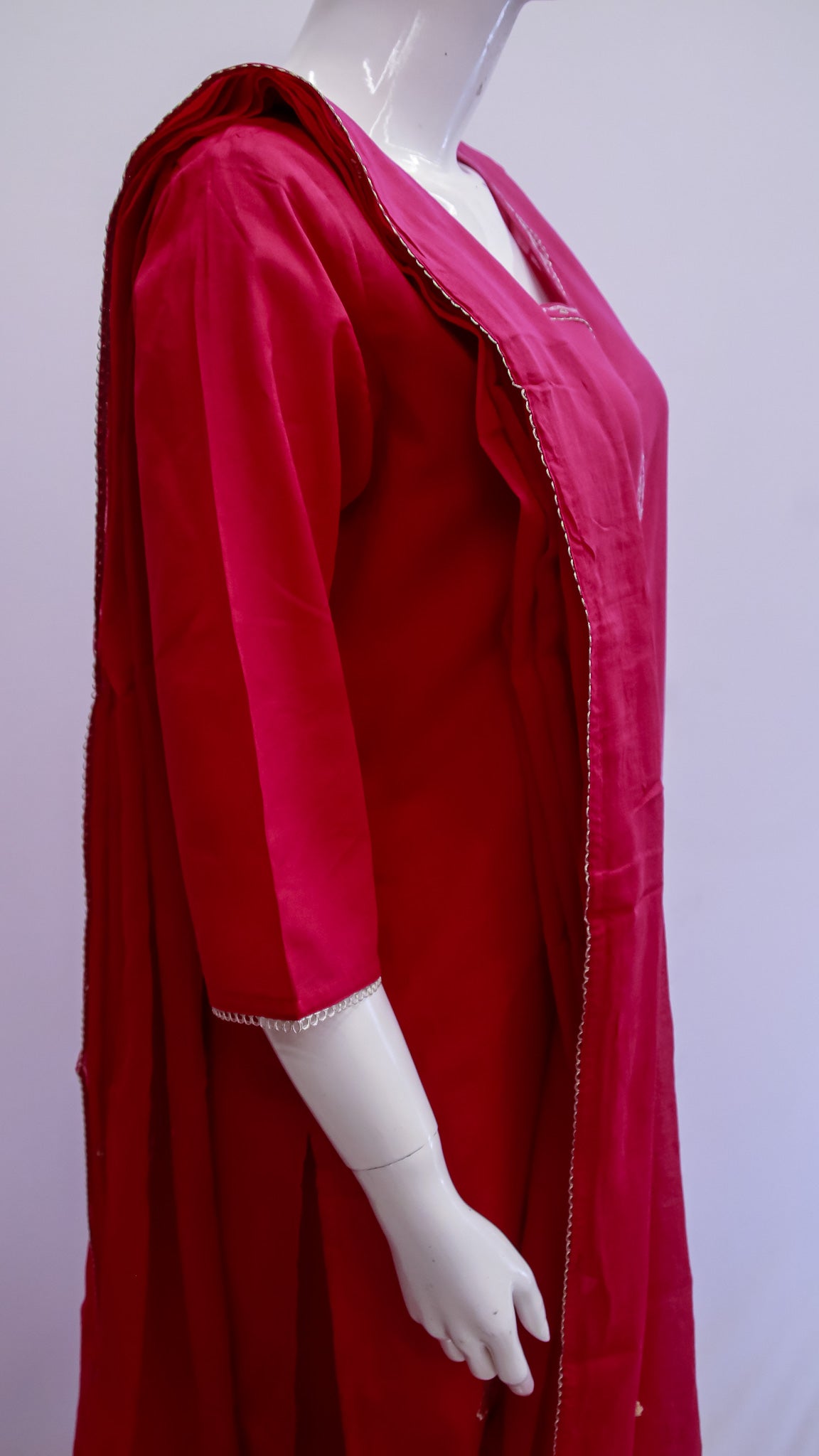 Red dress with a hood on a mannequin against a white background