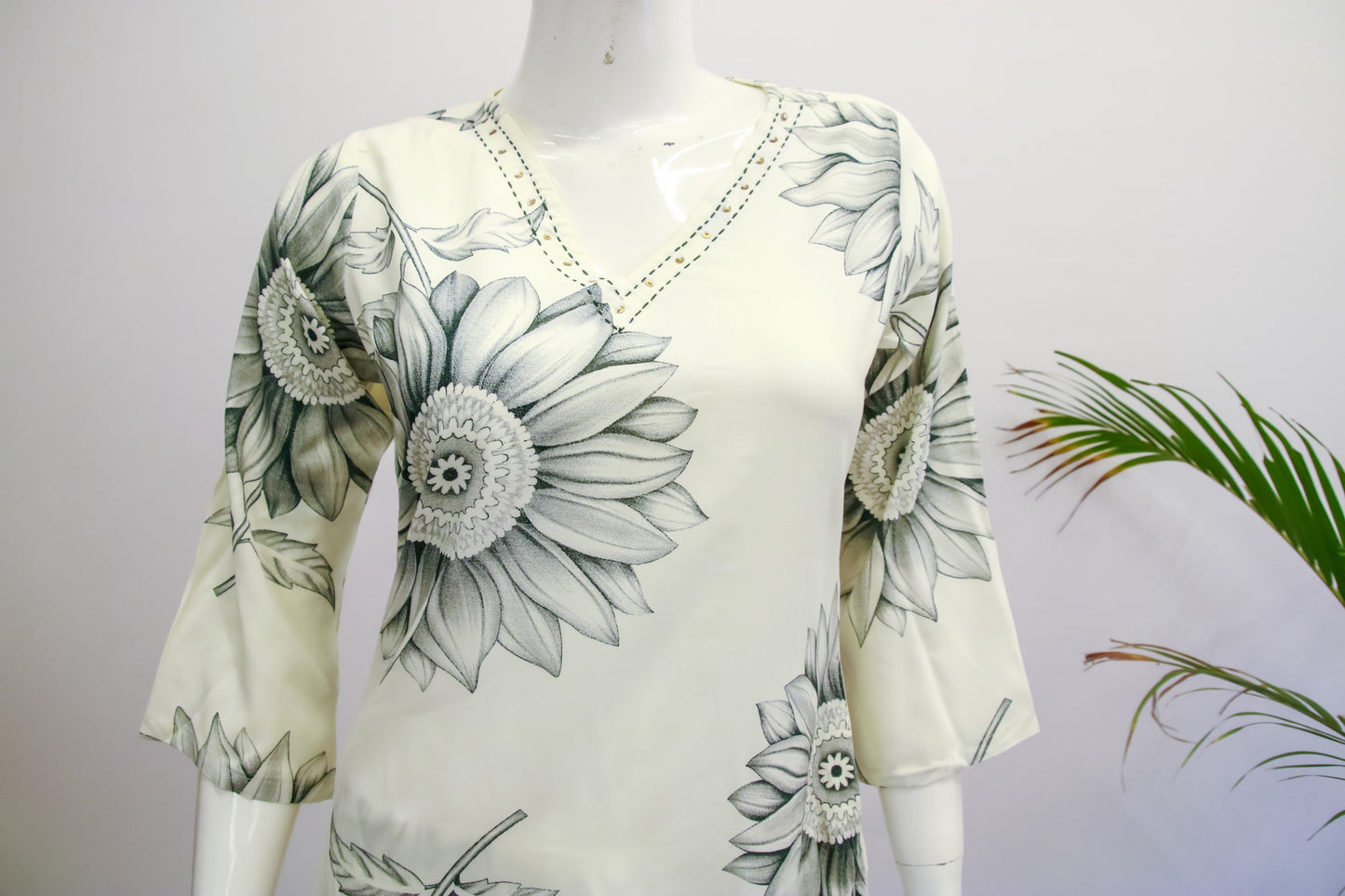 Floral patterned top on a mannequin with a white background