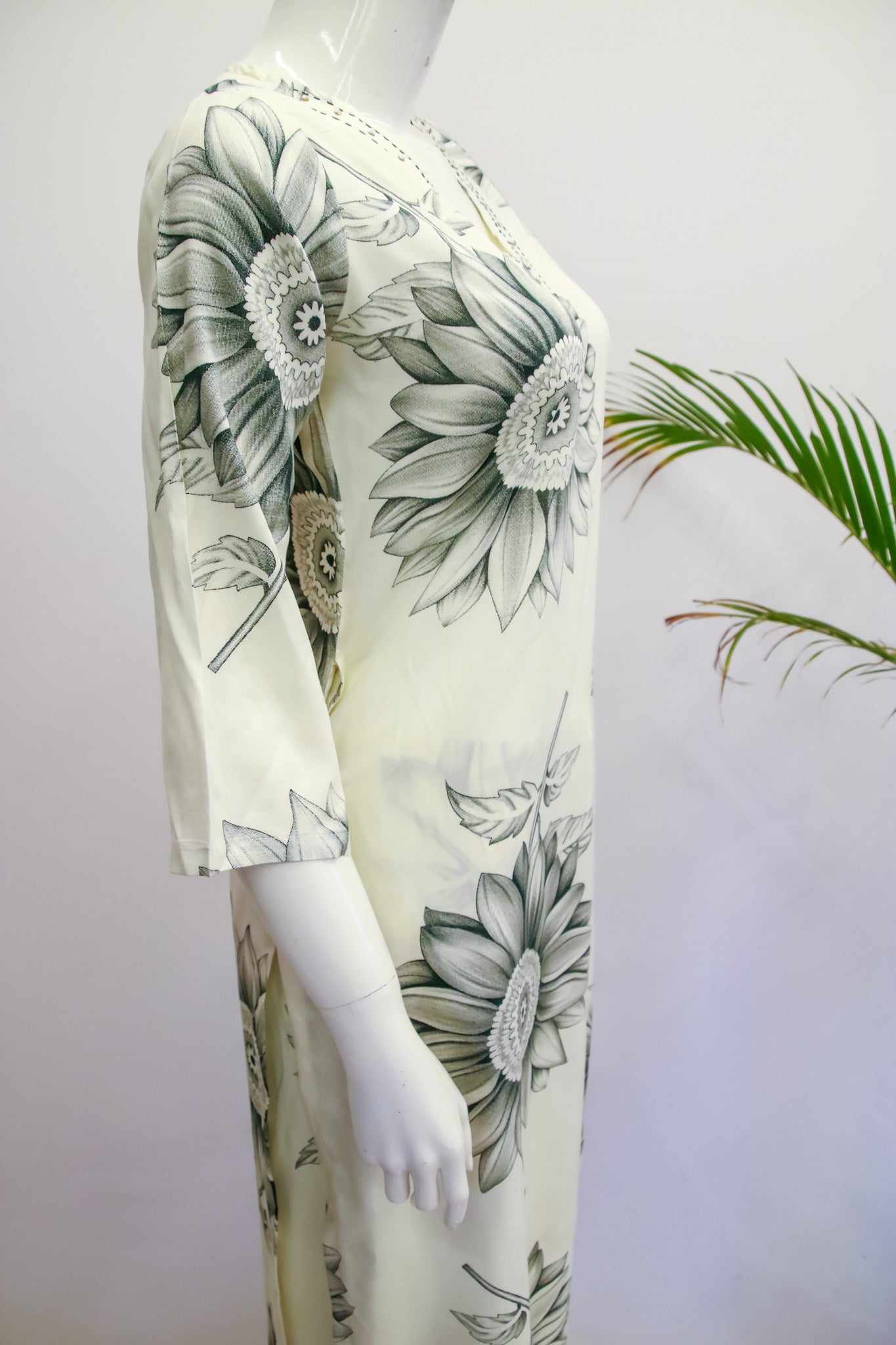 Mannequin wearing a floral dress with a white background
