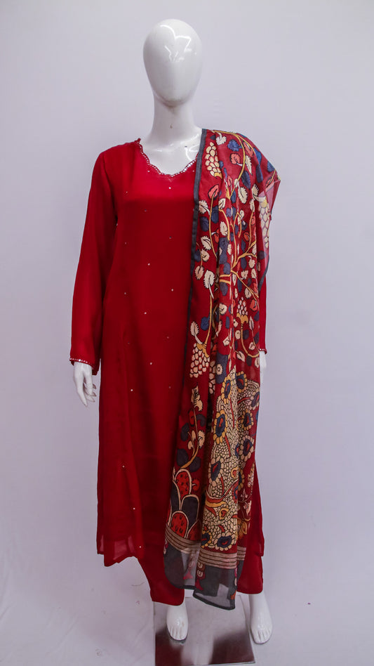 Red dress with a patterned scarf on a mannequin against a white background