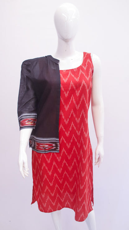 Red and black patterned dress on a mannequin against a white background