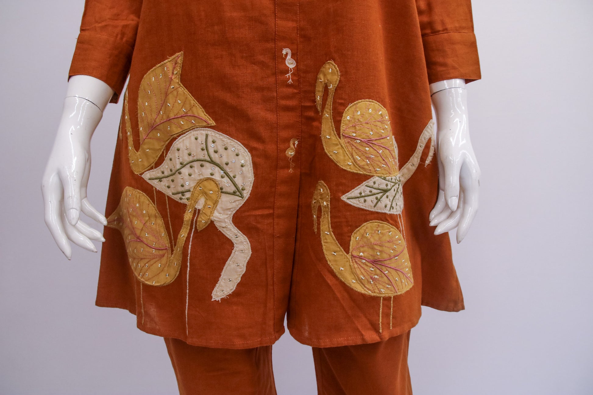 Brown outfit with floral patterns on a white background