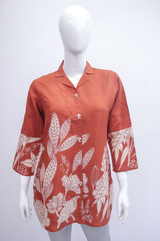 Red floral patterned shirt on a mannequin against a white background