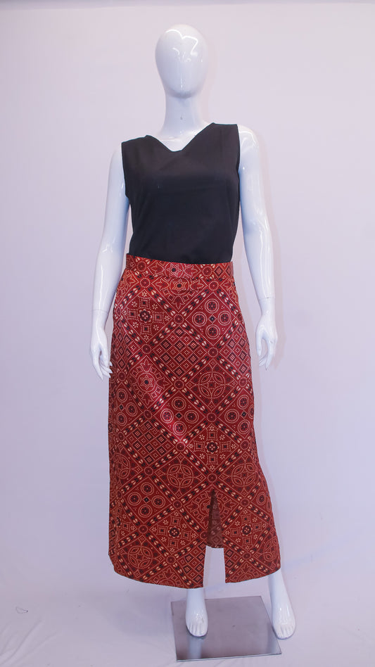 Mannequin wearing a black top and red patterned skirt on a white background