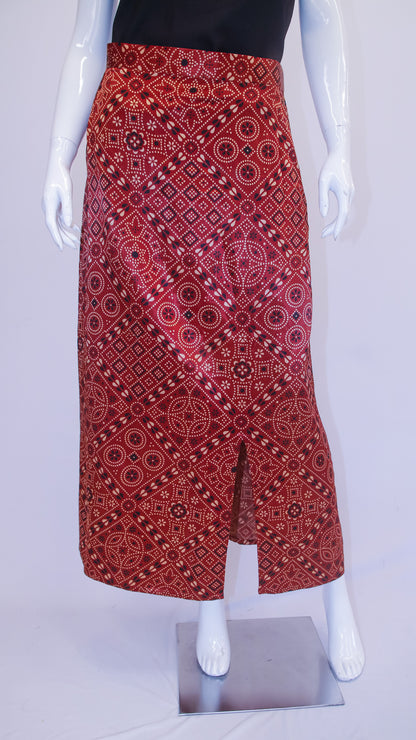 Red patterned skirt on a mannequin against a white background