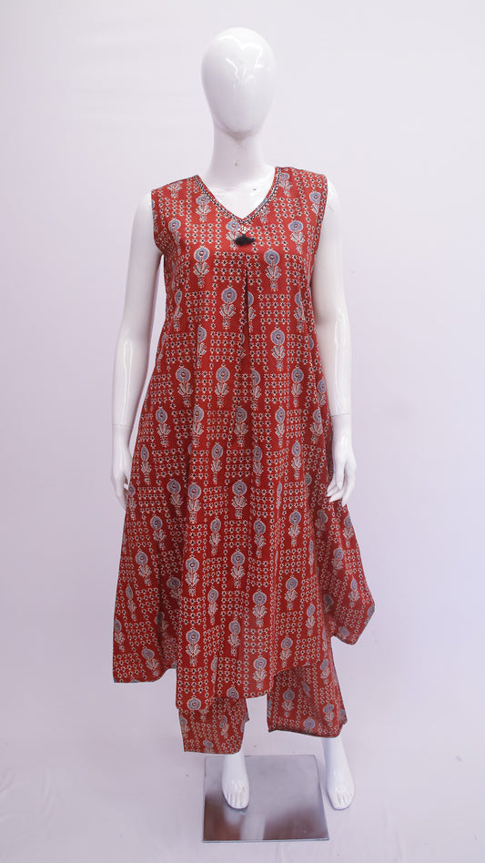 Red patterned dress on a white mannequin against a white background