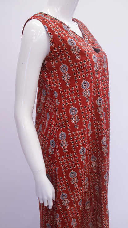 Red patterned dress on a mannequin against a white background