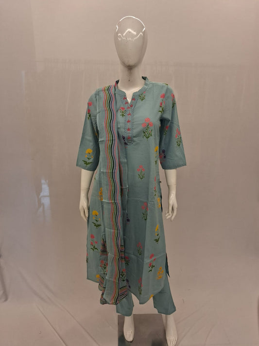 Mannequin wearing a light blue embroidered dress on a plain background