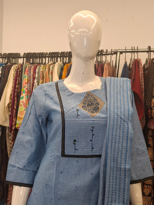 Mannequin wearing a blue embroidered kurta with a matching dupatta in a clothing store setting.