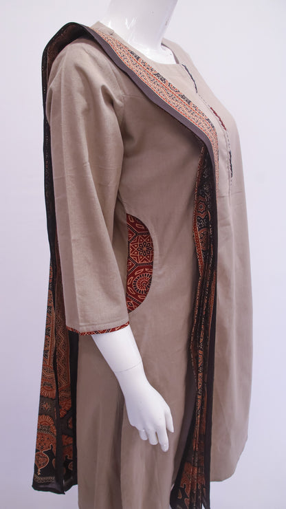 Mannequin wearing a beige dress with a patterned trim on a white background