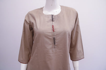 Beige kurta with embroidered details on a mannequin against a white background