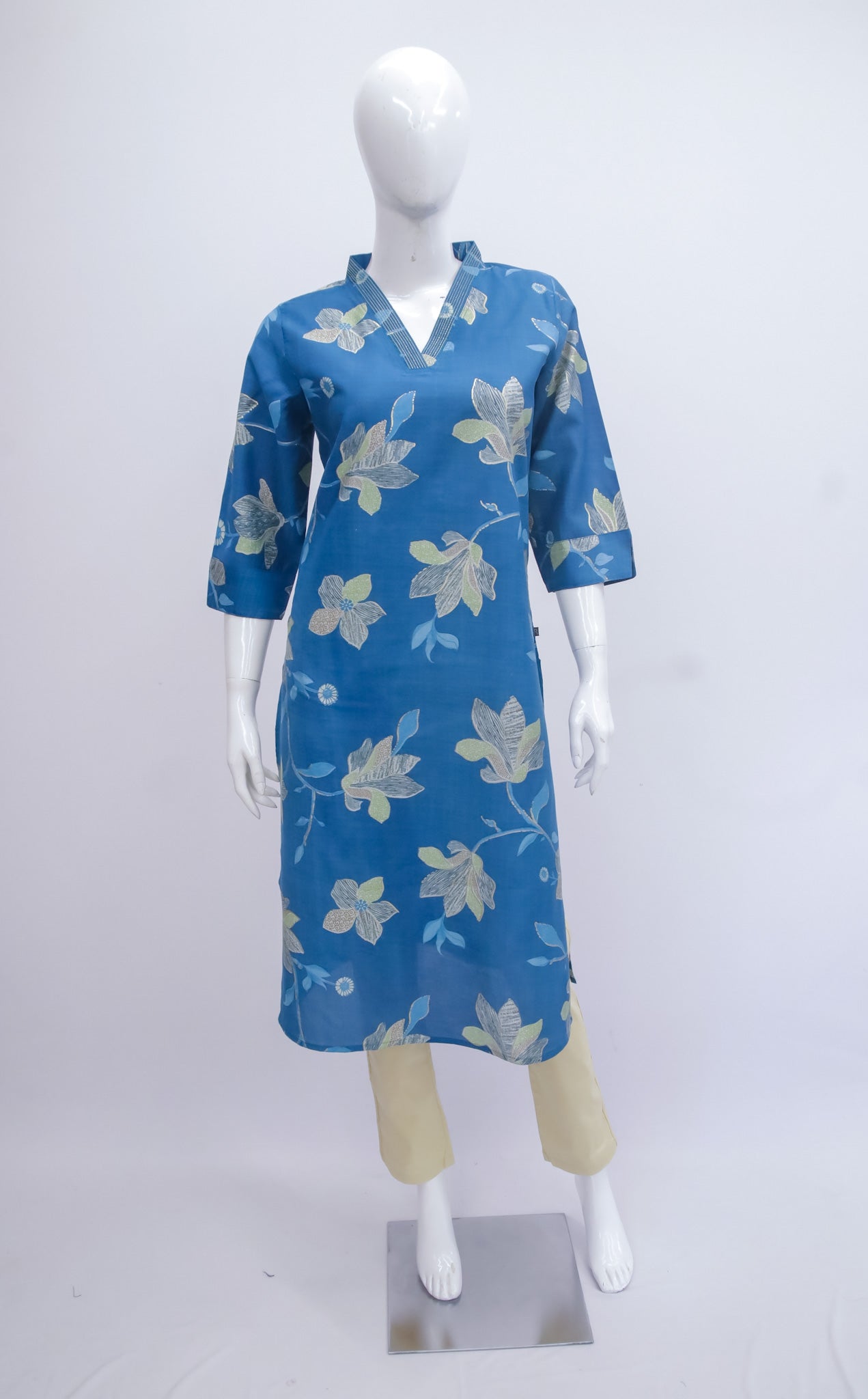 Blue floral dress on a mannequin against a white background