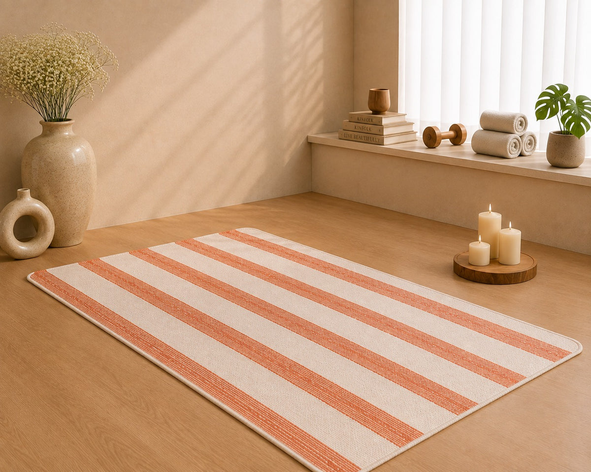 Udojas Sutra premium natural cork yoga mat with deep rose base, partially rolled in a luxury yoga studio.

