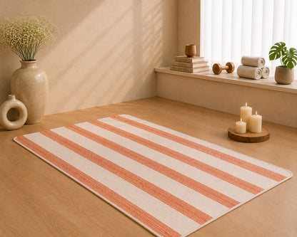 Udojas Sutra premium natural cork yoga mat with deep rose base, partially rolled in a luxury yoga studio.
