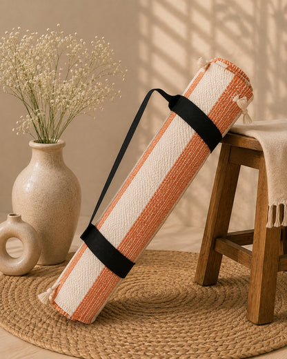 Udojas Sutra premium natural cork yoga mat with deep rose base, partially rolled in a luxury yoga studio.

