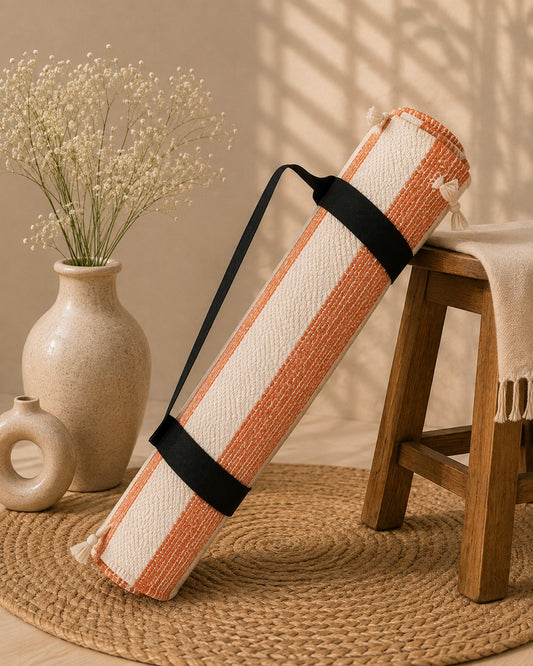 Udojas Sutra premium natural cork yoga mat with deep rose base, partially rolled in a luxury yoga studio.


